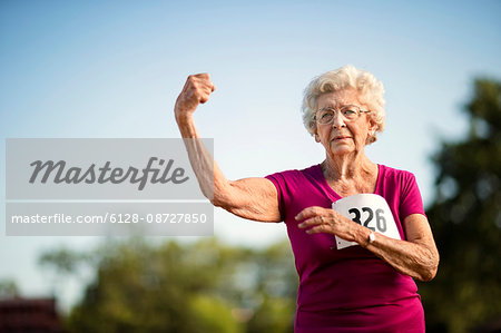 Strong Fit Mature Woman Flexing Her Arm Muscles Stock Image