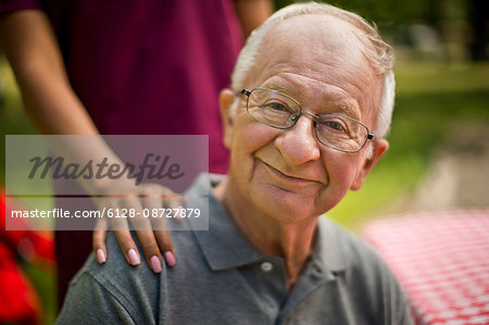 Portrait of a happy senior man at a picnic.