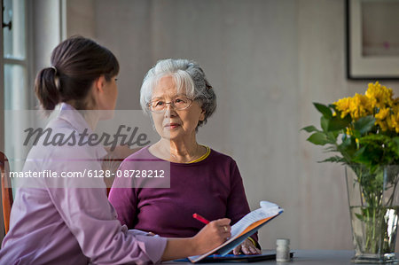 Elderly woman speaking with her doctor. Elderly woman speaking with her doctor.