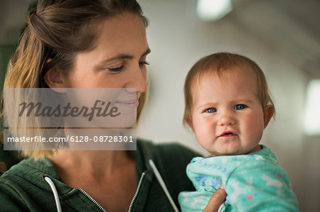 Happy mother holding her baby daughter.