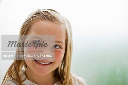 Smiling young girl wearing braces on her mouth.