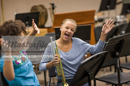 Two young woman reading music.