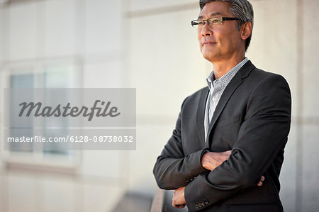 Businessman standing on balcony.