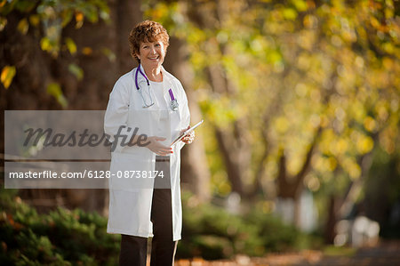 Portrait of a confident female doctor standing in a park.