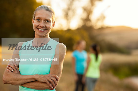 Portrait of a smiling mid adult woman standing in a rural field.
