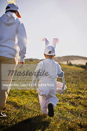 Two brothers in Easter costumes on an Easter egg hunt