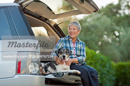 Happy senior woman bonding with her dog.