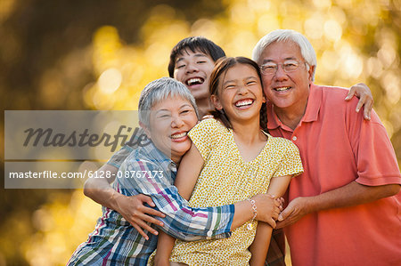 Portrait of smiling senior couple with their grandchildren.