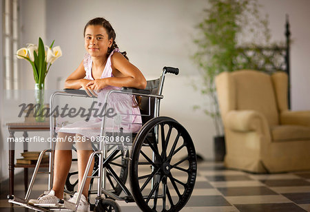 Portrait of young girl sitting in wheelchair.