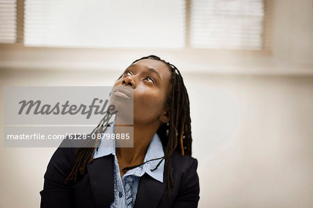 Woman with dreadlocks looking up to the sky