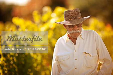 Senior man standing in his vineyard