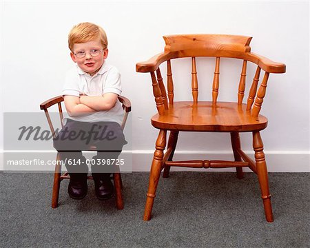 Premium Photo  Smiling little boy joying playing chess on wooden