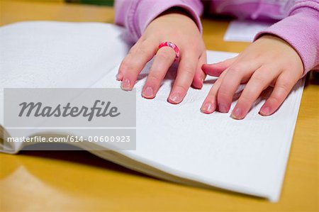 Blind girl reading braille