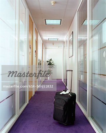 Suitcase in office corridor