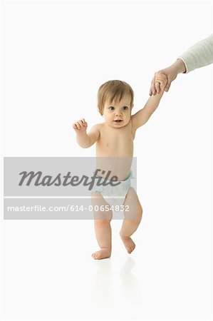 Adult helping baby to walk