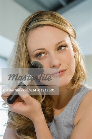 Woman applying face powder