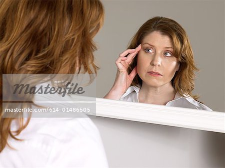 Woman looking in mirror
