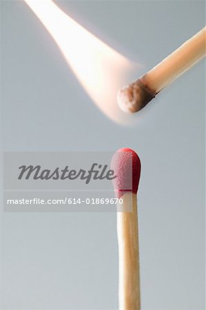 A burning and unlit match