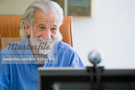 Senior man with webcam