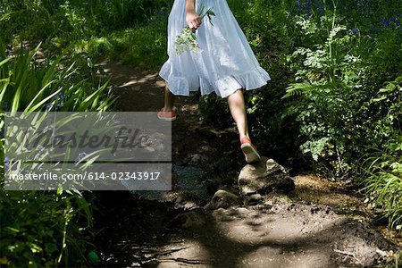 Woman walking in a garden