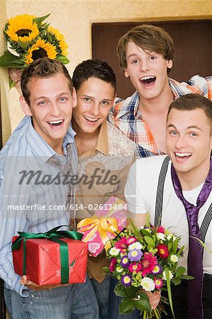 Portrait of friends with flowers and gifts