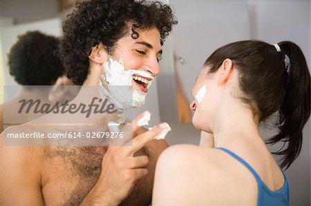 Couple playing with shaving foam