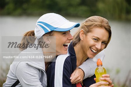 Two mature female friends laughing
