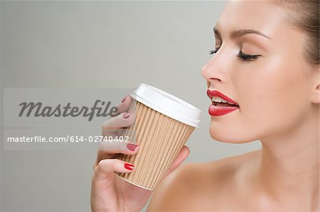 Woman Drinking Coffee Out Of A Paper Cup Stock Photo, Picture and