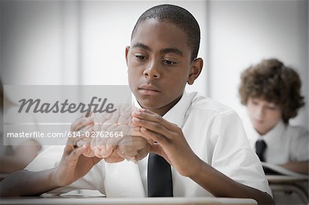 Boy with model of brain