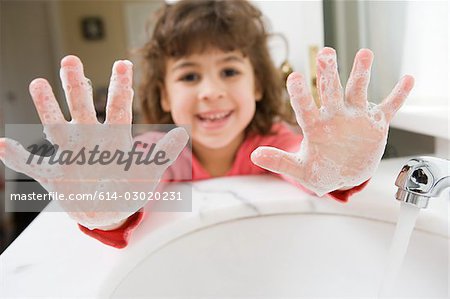 Girl with soap on her hands