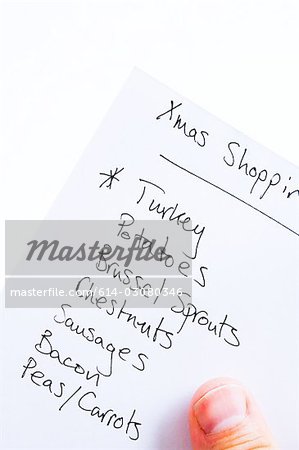 Person holding christmas shopping list
