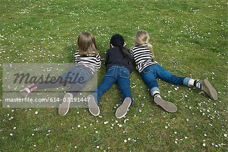 Three girls lying on grass