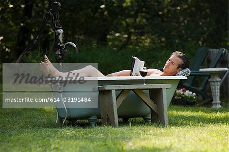 Man in outdoor bathtub