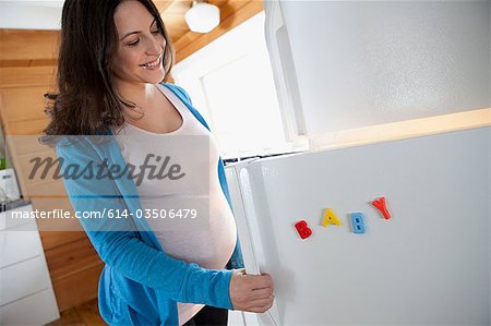 Pregnant woman by refrigerator