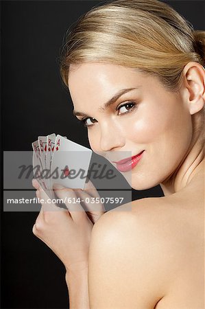 Young blonde woman playing cards
