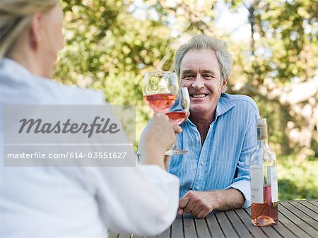 Couple toasting with wine outdoors