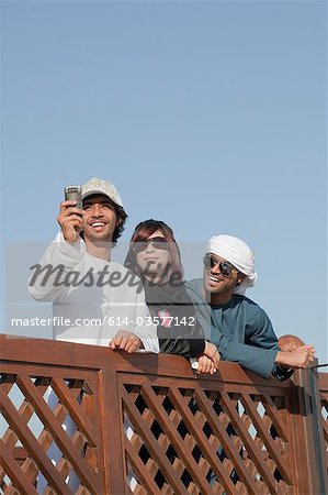 Middle Eastern people by fence, low angle view