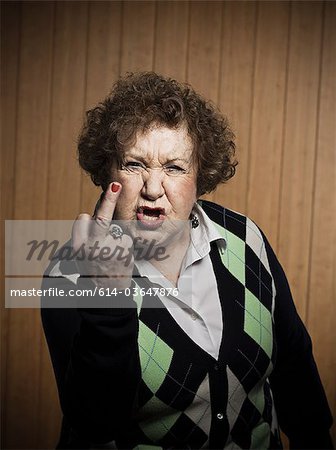 Senior woman making obscene gesture Senior woman making obscene gesture