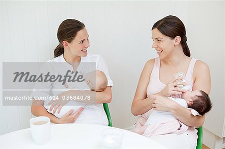 Two mothers with their babies
