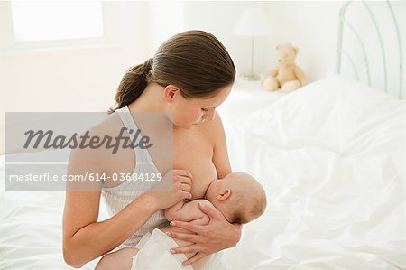 Mother breast feeding baby son