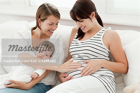 Mother with baby and pregnant friend