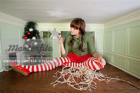 Young woman in small room with christmas decorations