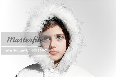 Girl wearing a white coat with fur hood