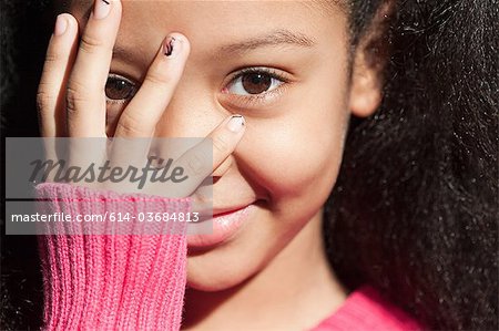 Girl putting her hand on her face - Stock Photo - Masterfile