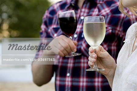 Couple tasting wine in vineyard