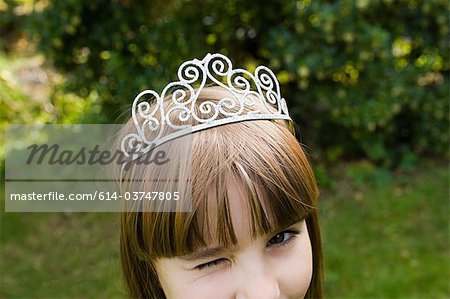 Girl wearing tiara and winking