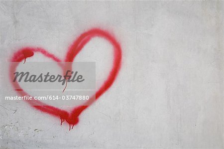 Red heart shape on white wall