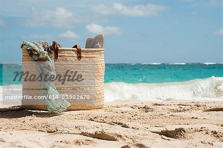 Beach bag on sandy beach, Mustique, Grenadine Islands