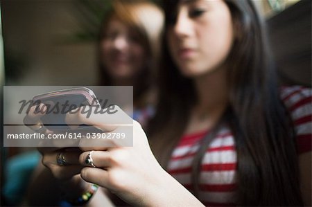 Two teenage girls using smartphone