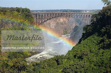 Rainbow over the Zambezi River and Victoria Falls Bridge.  Zambia on right of  bridge, Zimbabwe on left
